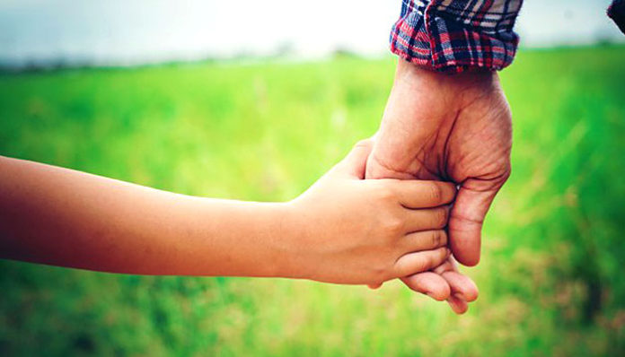 close up of father holding his daughter hand so sweet family ti 1150 846 696x398